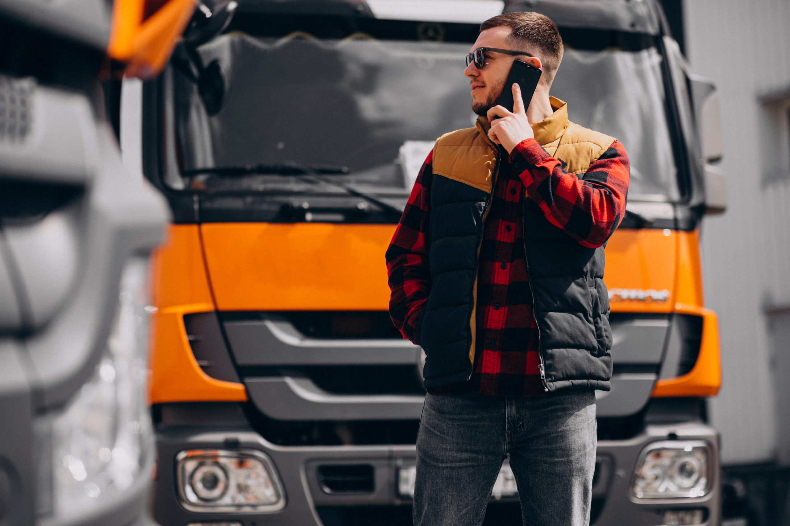 Handsome man truck driver standing by the truck